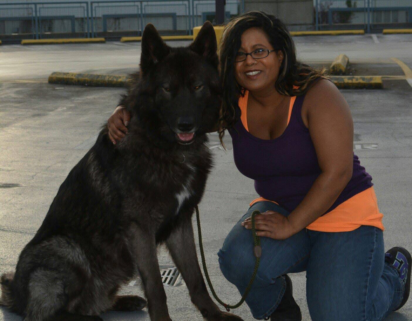 Sharmeen with a large shepherd dog, demonstrating confidence and trust with powerful breeds